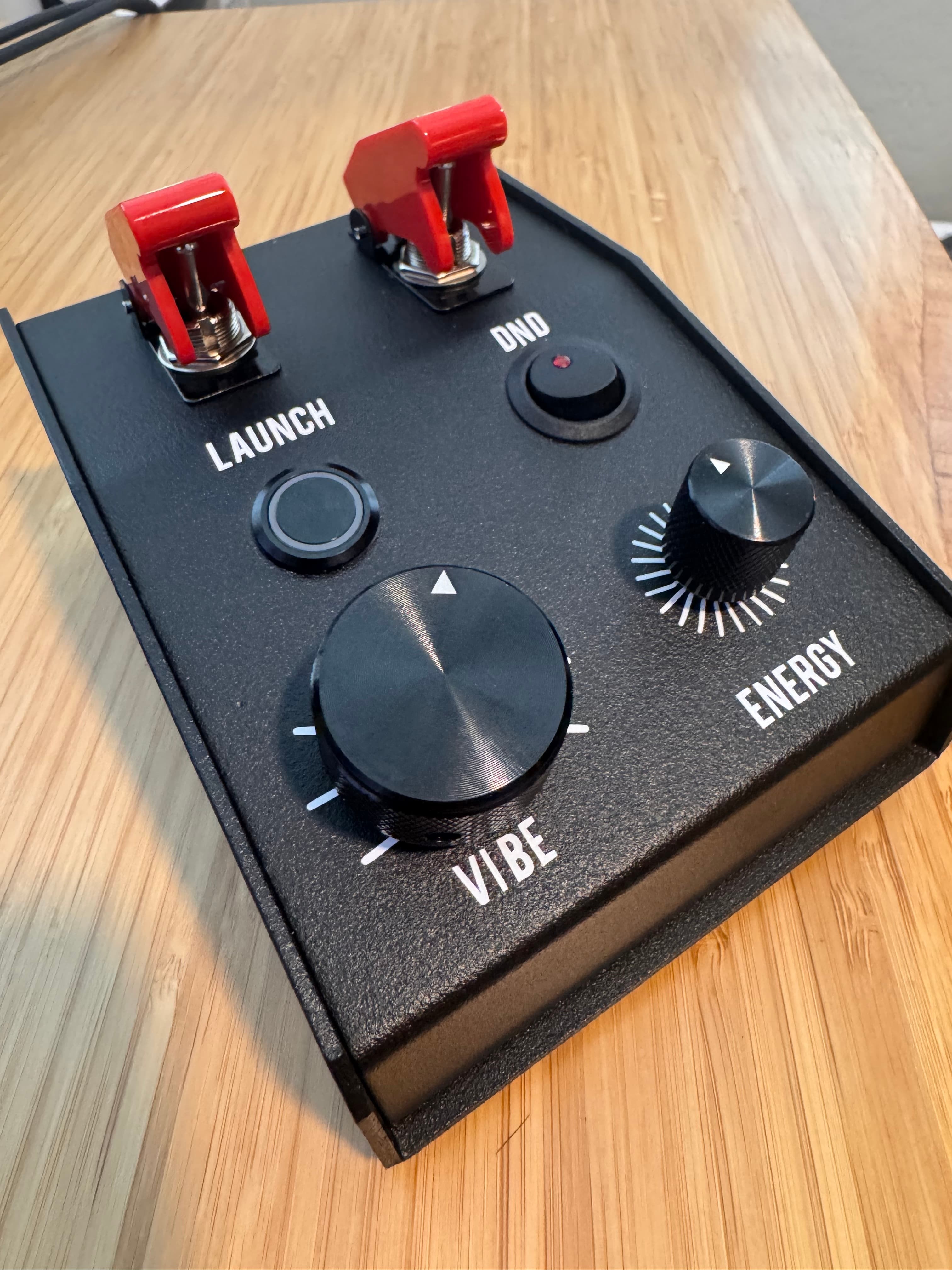 Deadband prototype — front view showing guarded toggles and brushed knob